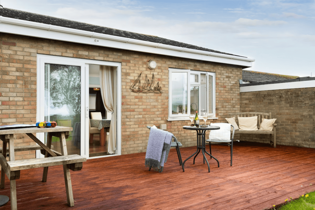 Cozy patio with furniture at brick house