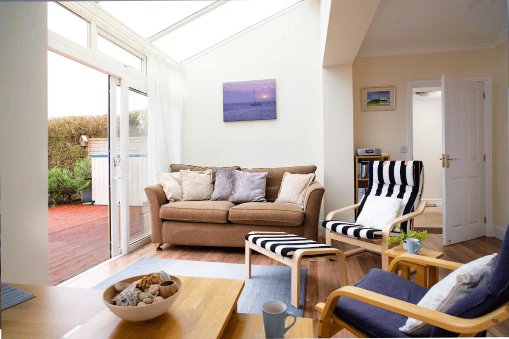 Cozy living room with open sliding door to garden