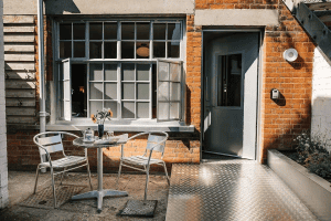 Cozy outdoor cafe seating next to a brick building