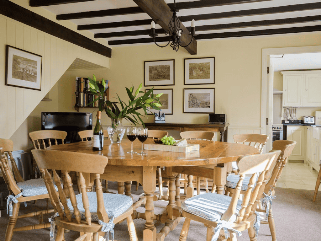 Cozy dining room with wooden table, chairs, and beams