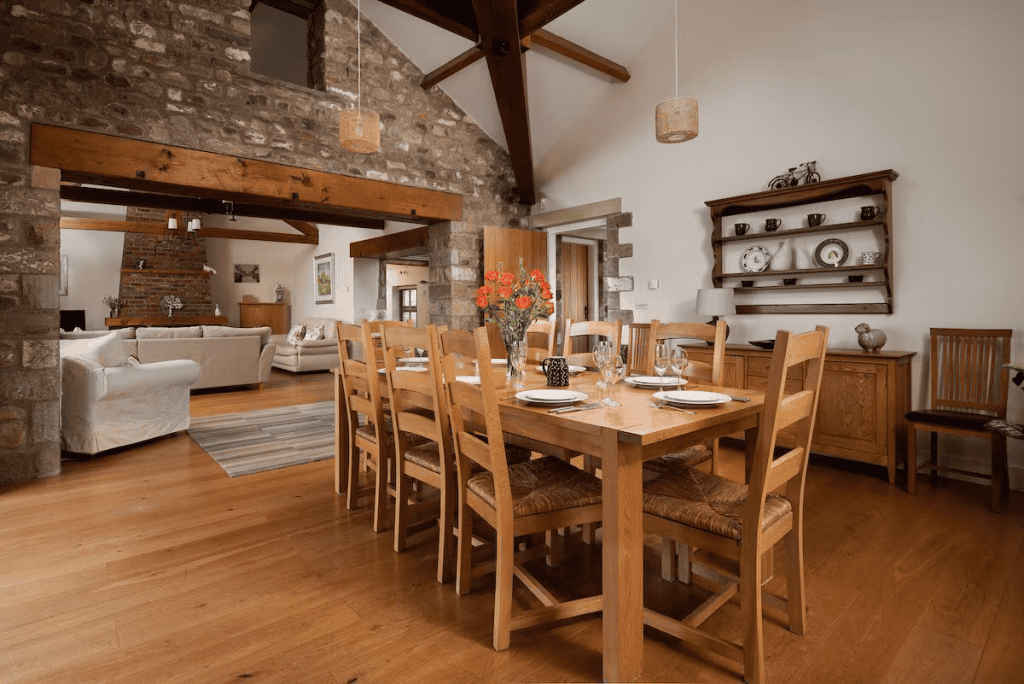 Rustic dining room with exposed stone walls and beams