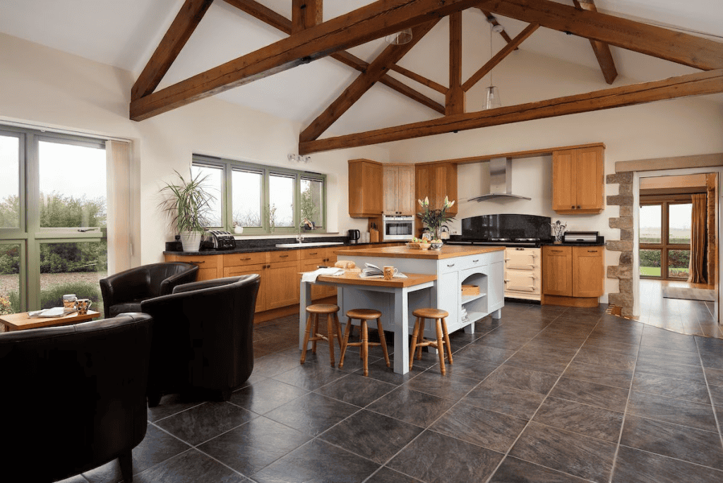 Spacious kitchen with wooden beams and modern appliances