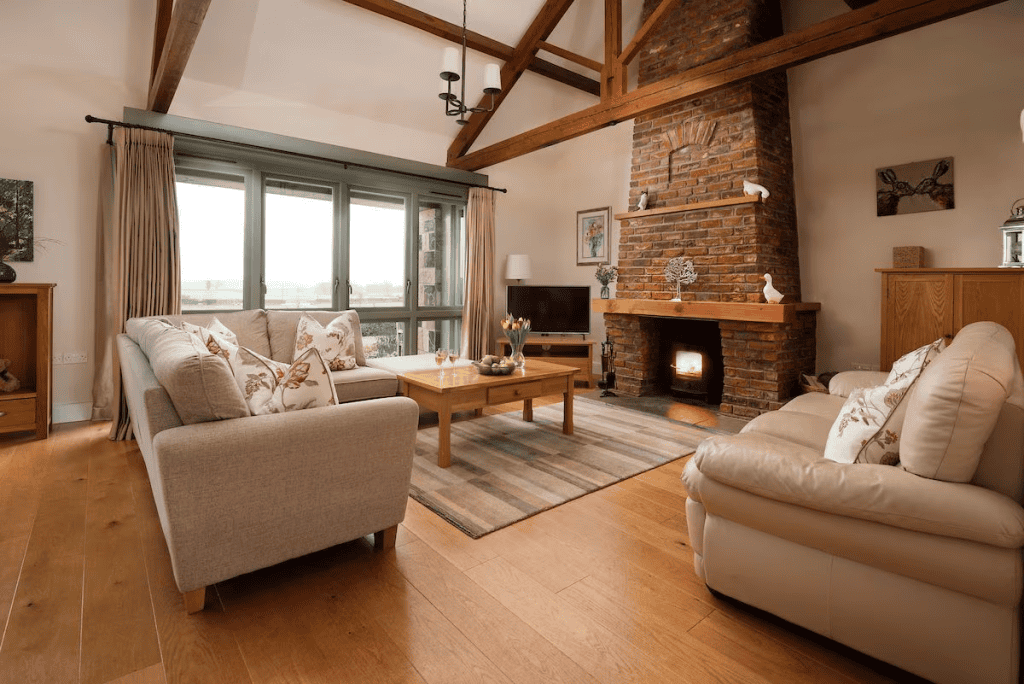 Cozy living room with fireplace and countryside view