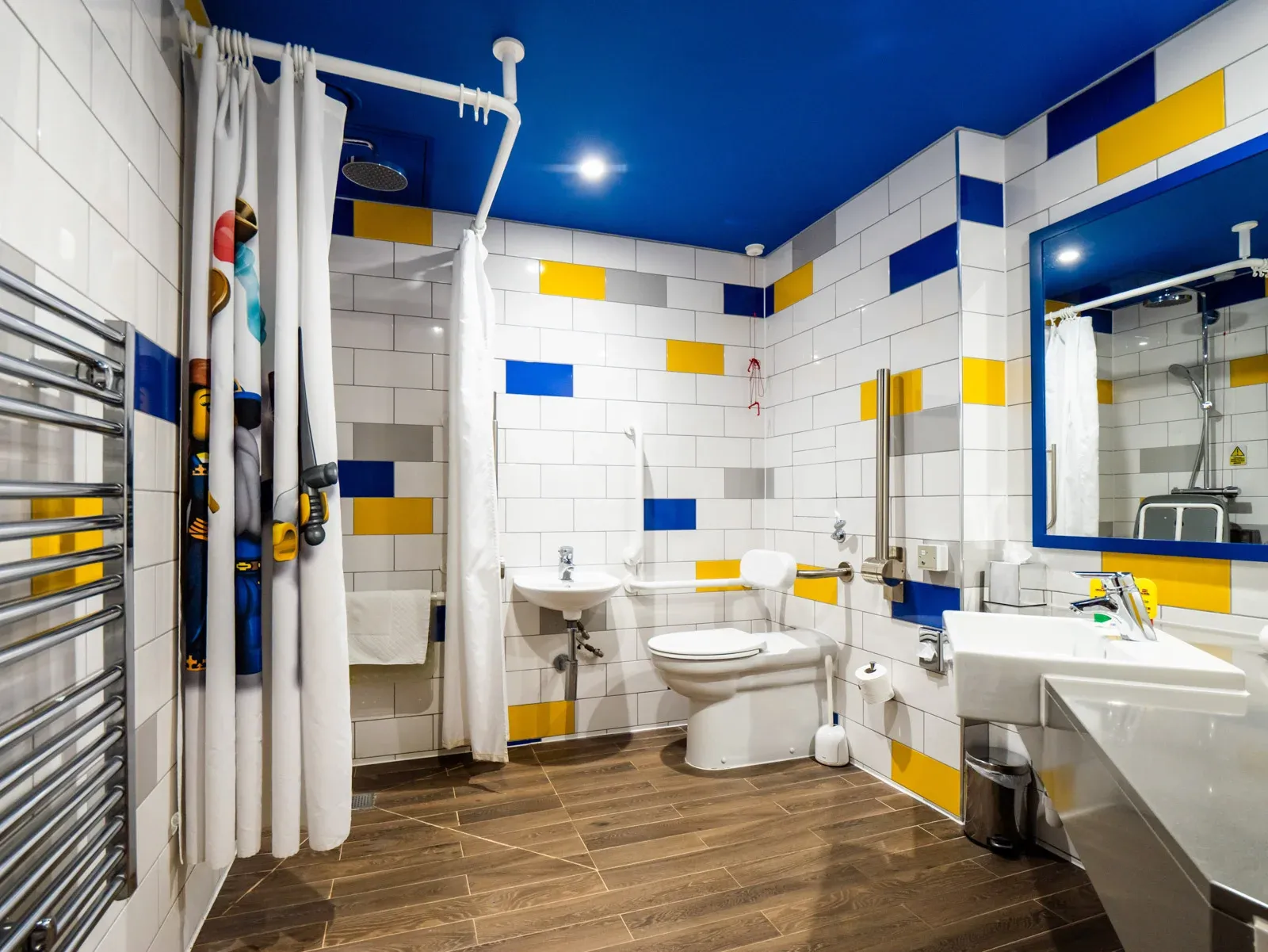 Modern accessible bathroom with blue and yellow tiles