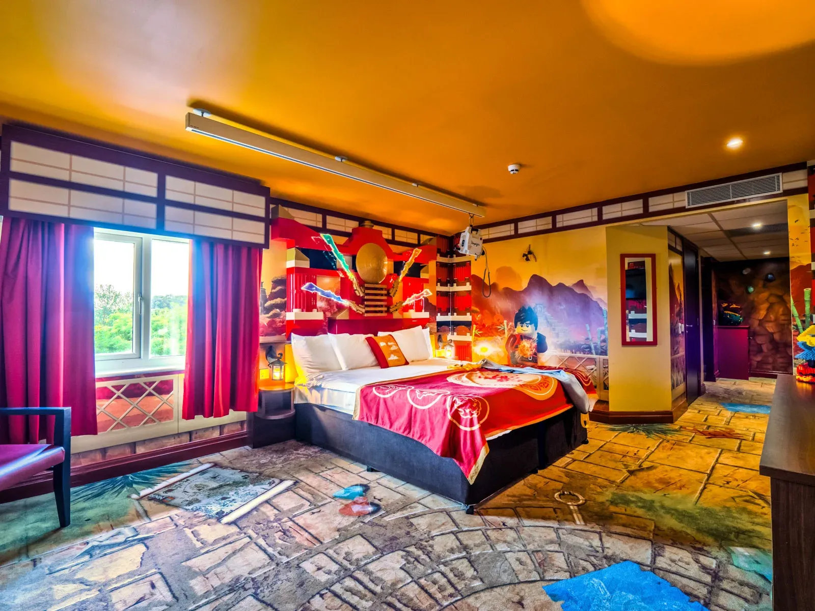 Colorful themed hotel room with vibrant decor and mural