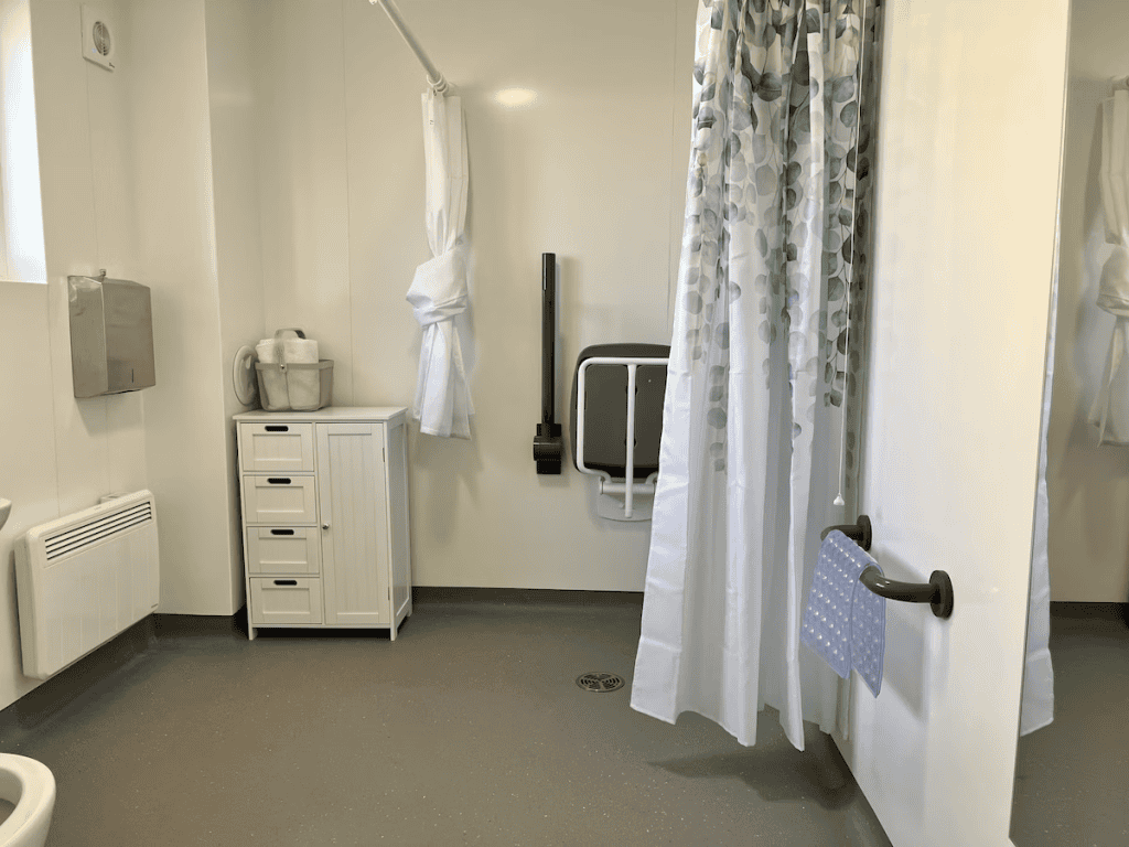 Accessible hospital bathroom with privacy curtains and grab bars