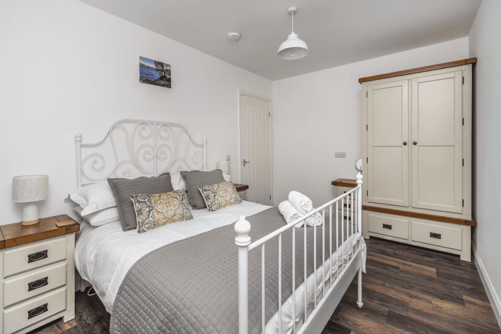 Elegant bedroom with white vintage metal bedframe