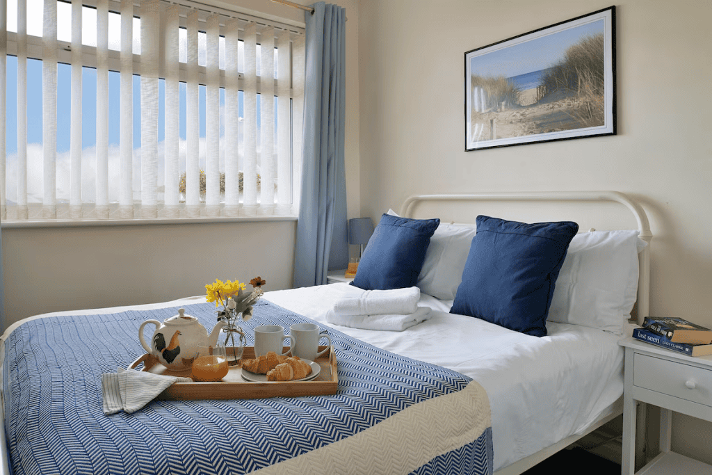 Cozy bedroom with breakfast tray and sunny window view