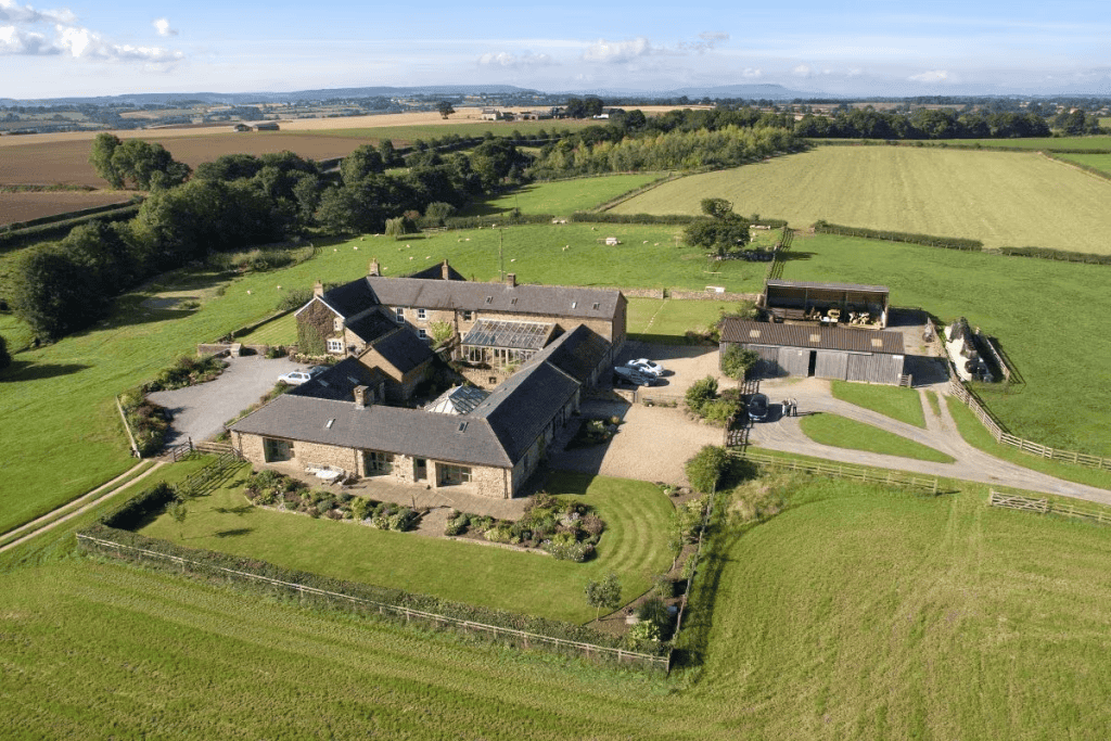 Aerial view of a large countryside estate with fields.