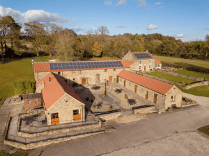 Aerial view of stone buildings with solar panels