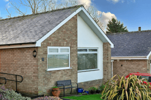 Suburban brick house with large windows and garden