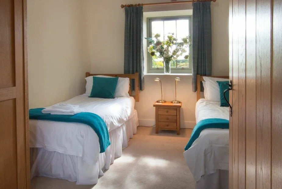 Cozy twin bedroom with teal accents and natural light