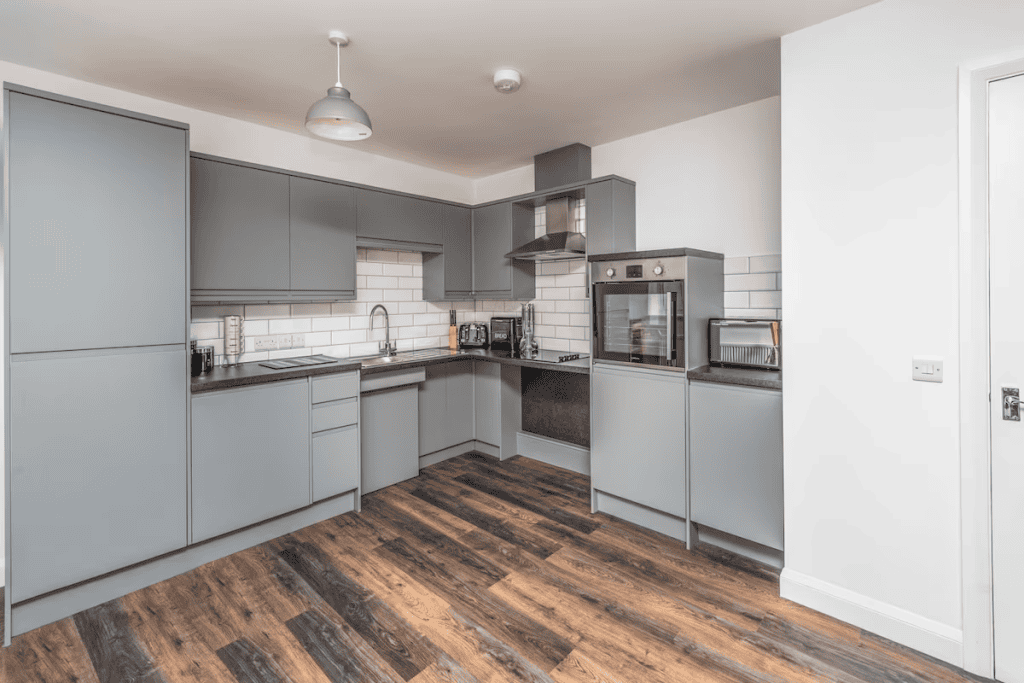 Modern gray kitchen with appliances and white subway tiles