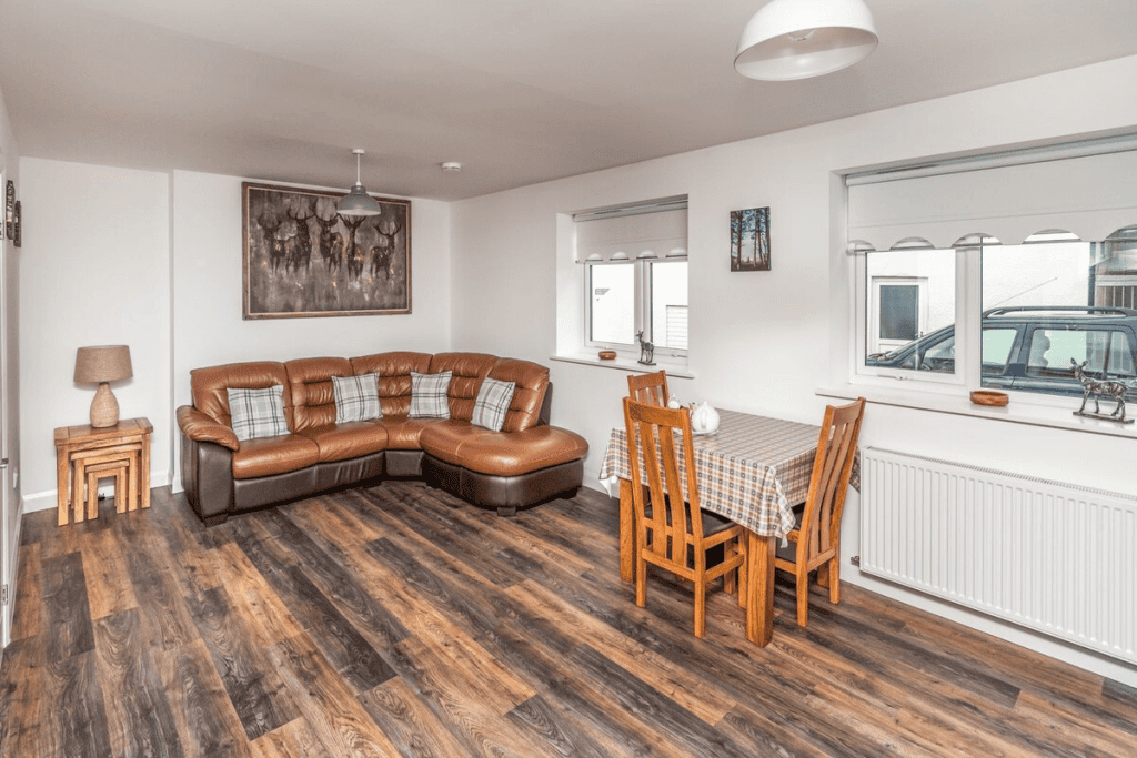 Spacious living room with sectional sofa and dining table