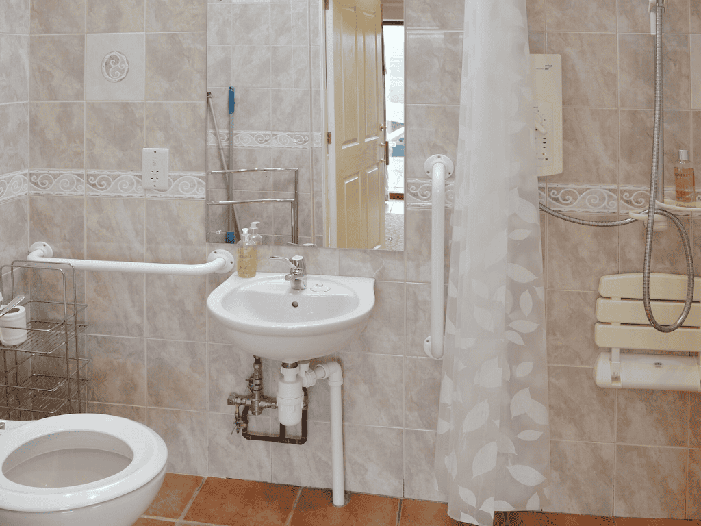 Accessible bathroom with grab bars and tiled walls