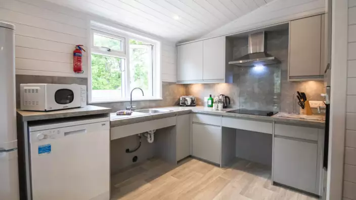 Modern kitchen with white cabinets and stainless appliances