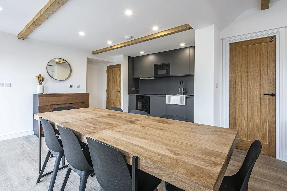 Kitchen dining area with low height ammenities and dining table with free standing seating
