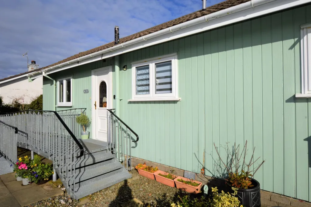 Mint green house with white door and window