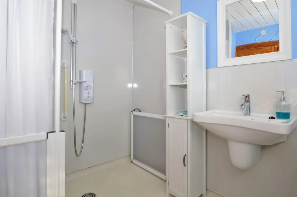 Modern bathroom with white fixtures and blue walls