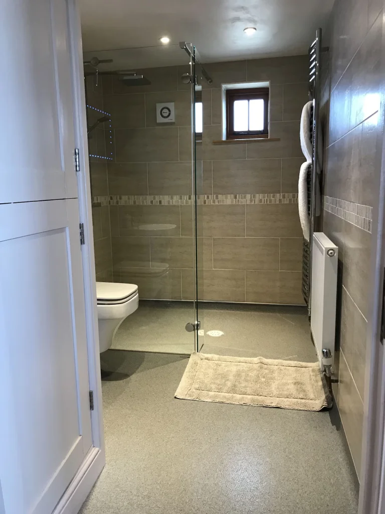 Step free shower with glass seperator