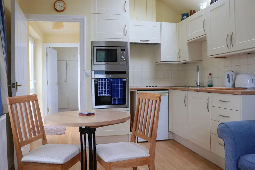 Bright kitchen with wooden furniture and modern appliances