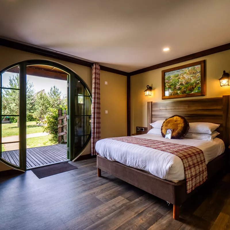 Cozy bedroom with open patio door leading to garden
