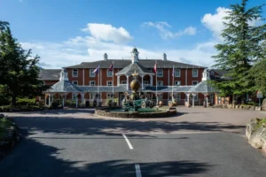 Historic hotel front with decorative fountain and flags