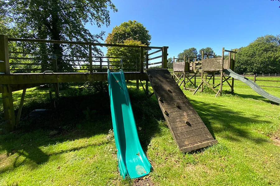 Wooden playground with slide in sunny park