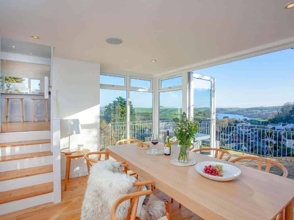 Bright sunlit dining room with scenic lake view