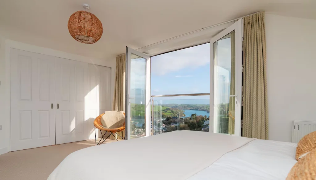 Bright bedroom with scenic lake view through large window