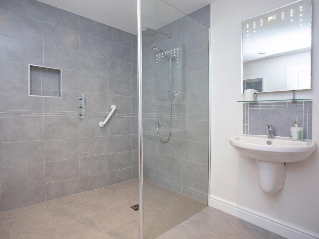 Modern bathroom with tiled walls and walk-in shower
