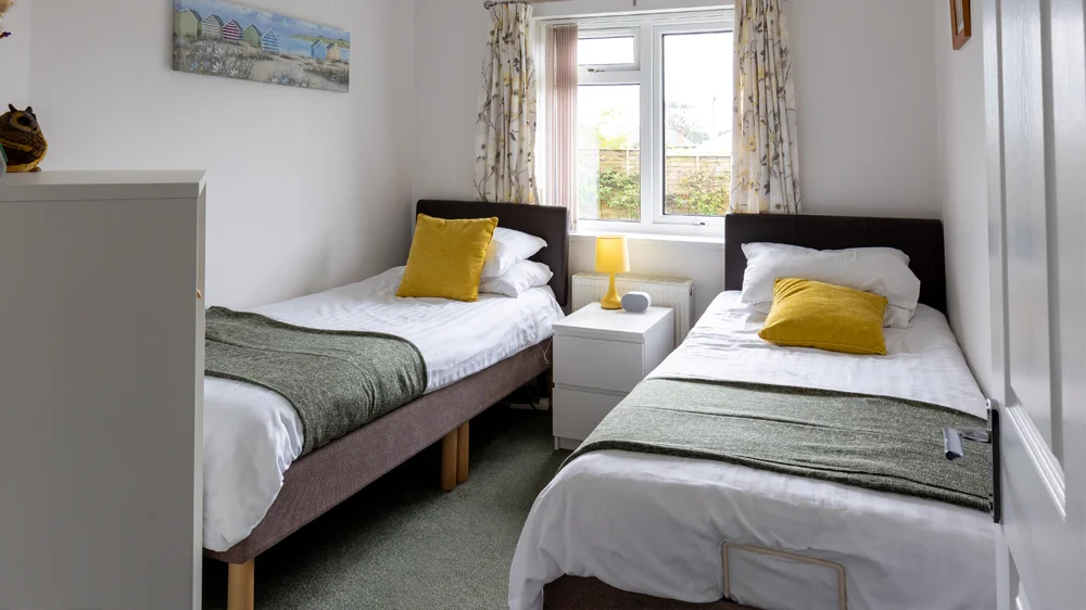 Bright twin bedroom with green and yellow accents