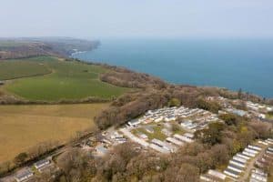 Aerial view of coastal caravan park near green fields