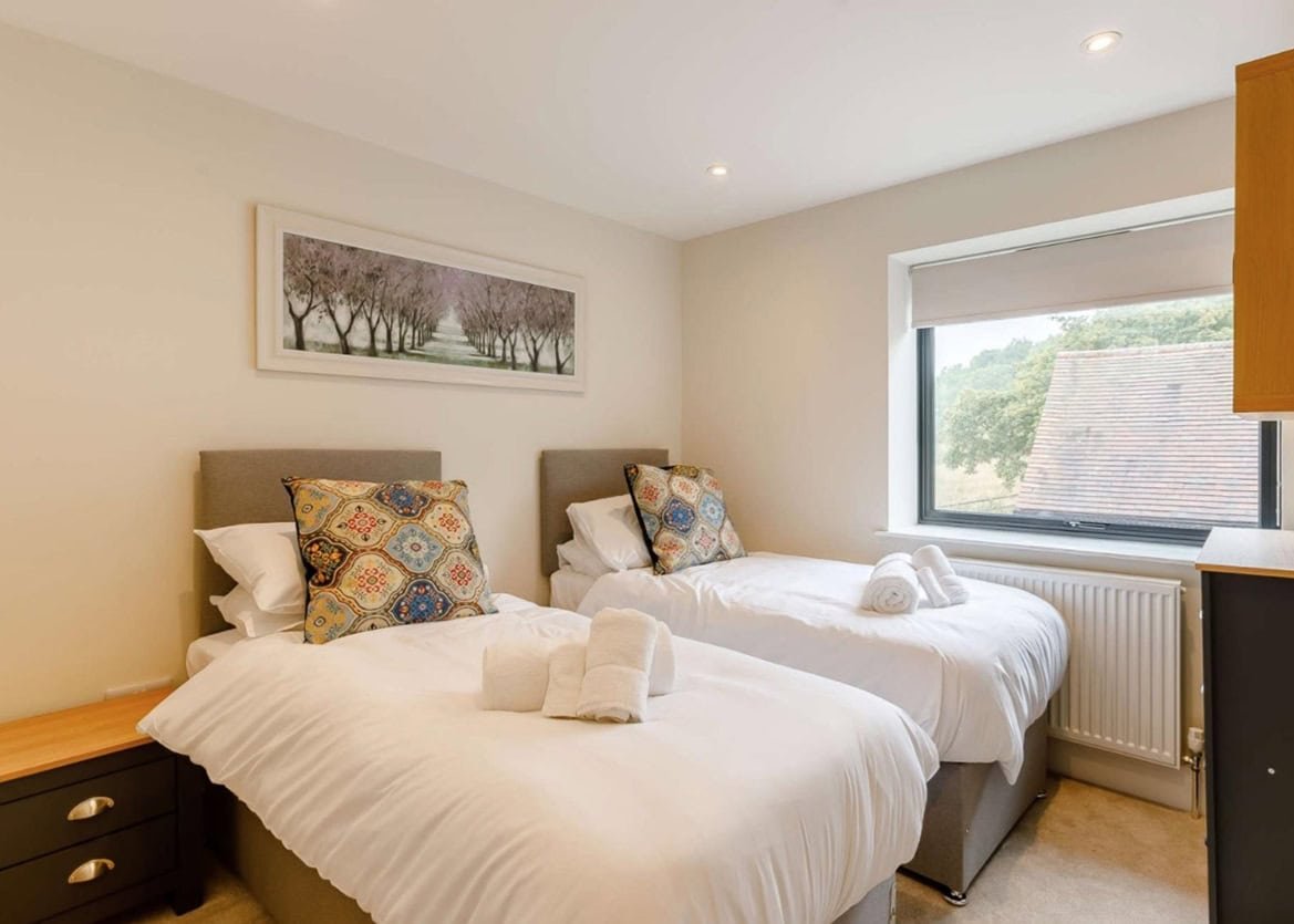 Bright twin bedroom with scenic window view