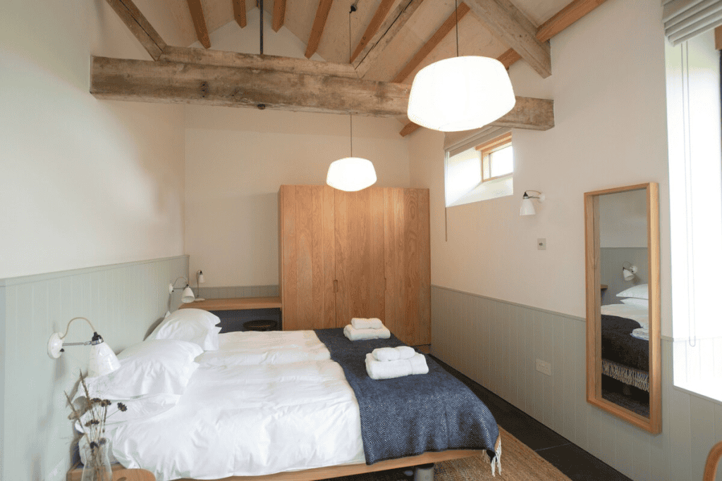 Cozy rustic twin bedroom with exposed wooden beams