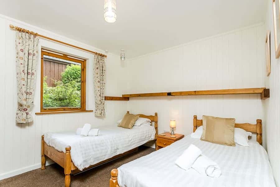 Cozy twin bedroom with garden view through window