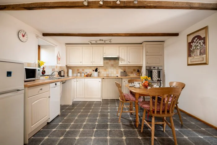 Cozy rustic kitchen interior with wooden beams and dining set