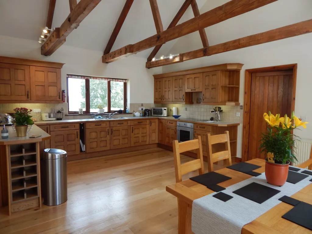 Spacious kitchen with wooden cabinets and exposed beams