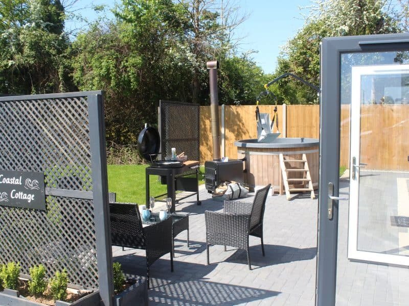 Inviting backyard patio with outdoor kitchen and dining set.