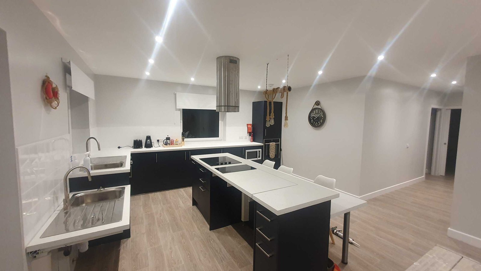 Modern kitchen with white and black cabinets and lighting