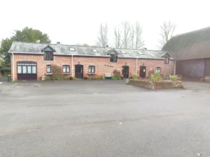 Brick building with garage and landscaped courtyard