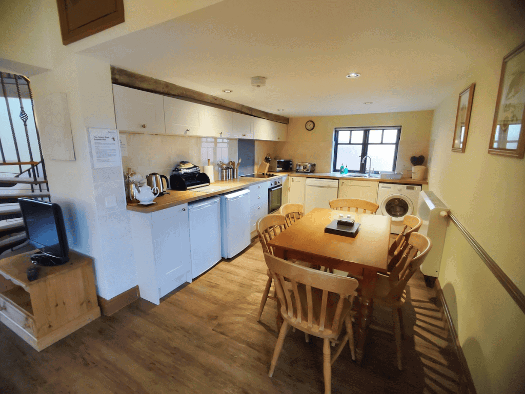 Cozy kitchen interior with dining table and staircase