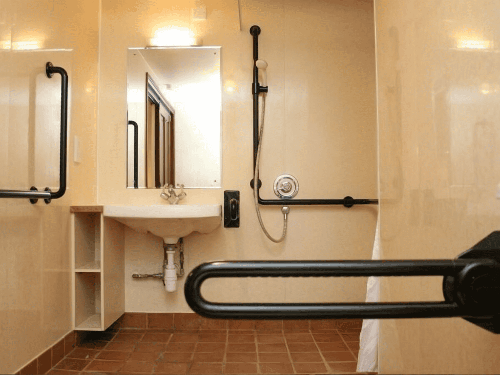 Accessible bathroom with handrails and mirror