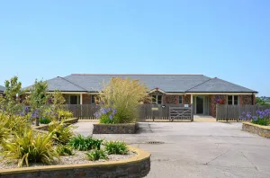 Single-story brick building with landscaped front yard