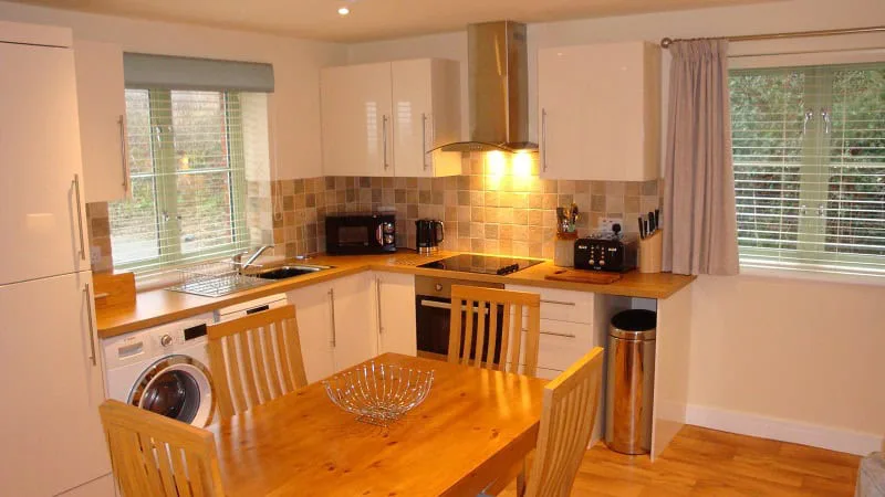 Modern kitchen with wooden dining table and appliances