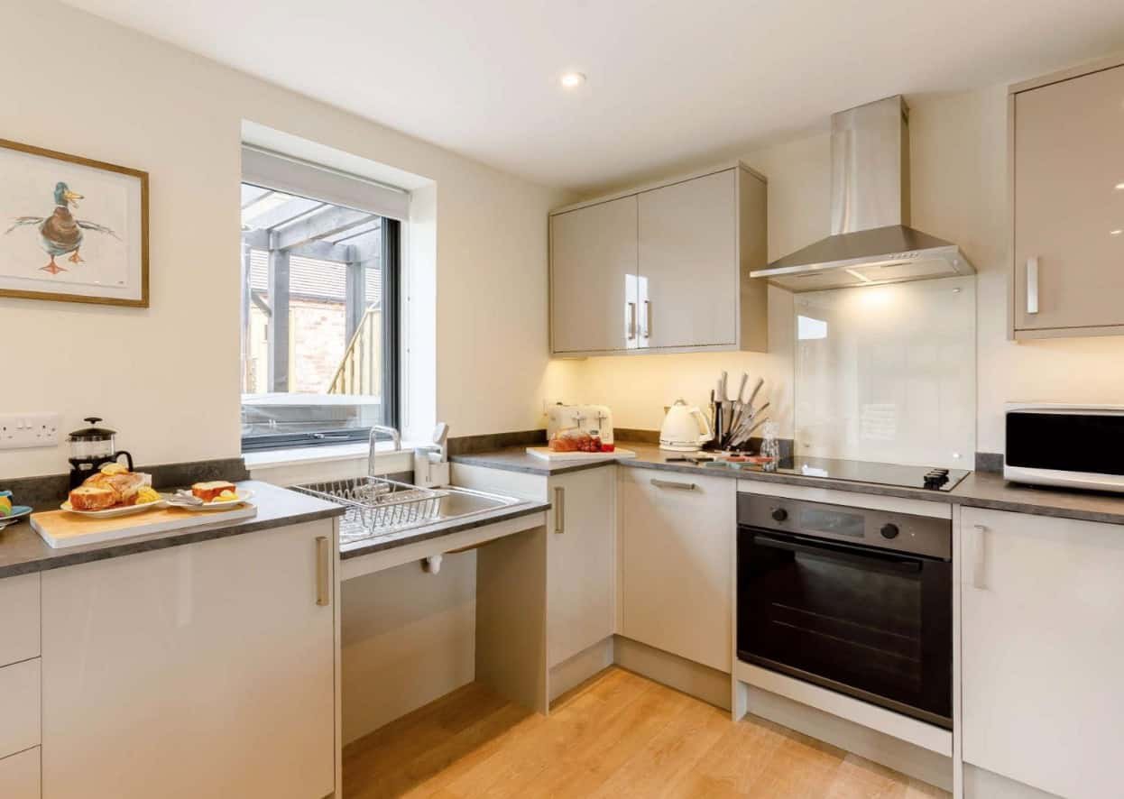 Modern kitchen interior with appliances and breakfast setup