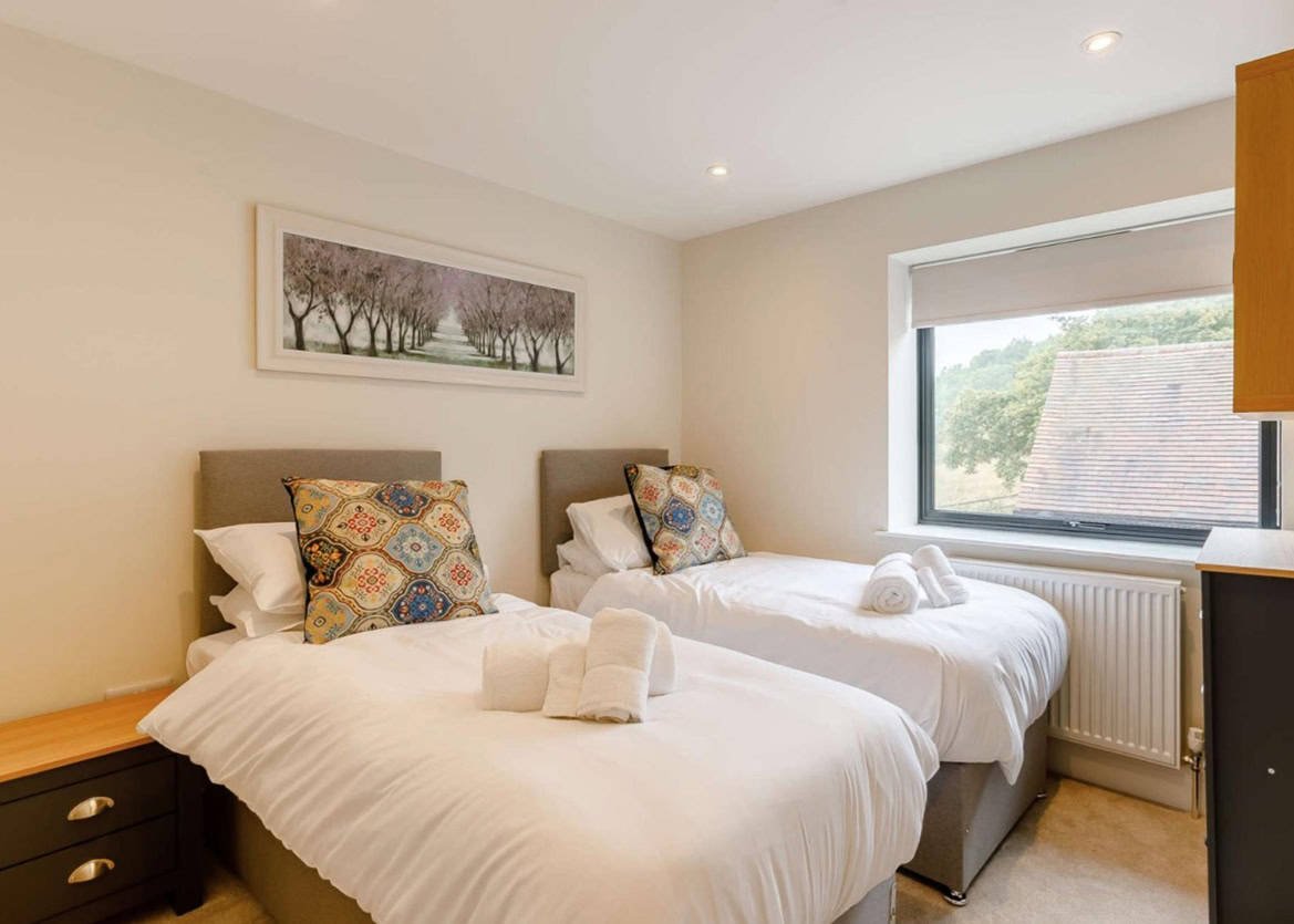 Bright twin bedroom with scenic window view