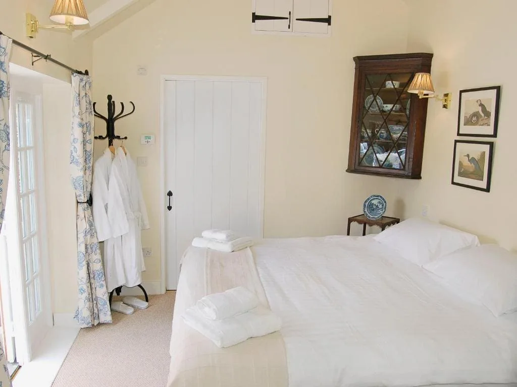 Cozy bedroom with white linens and vintage decor
