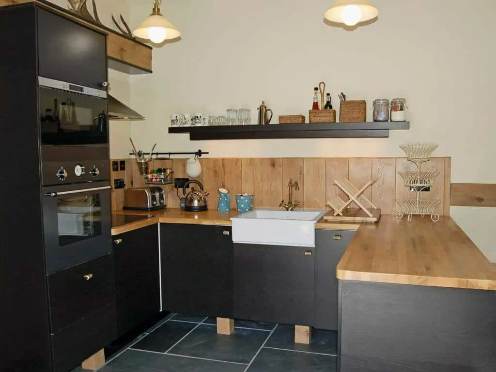 Modern kitchen with wooden counters and black cabinets