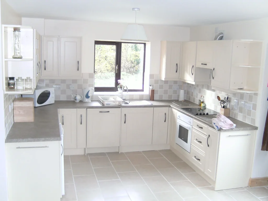 Bright modern kitchen with white cabinets and appliances